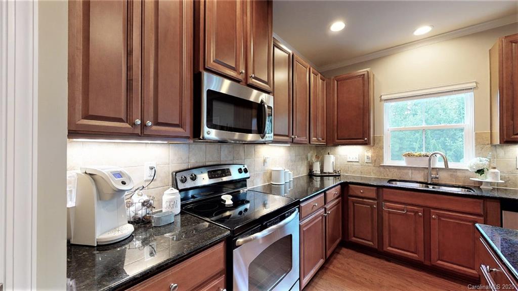 3010 Fallondale Road Waxhaw, NC 28173 - Photo 19 of 44 a kitchen with stainless steel appliances granite countertop a sink stove and microwave