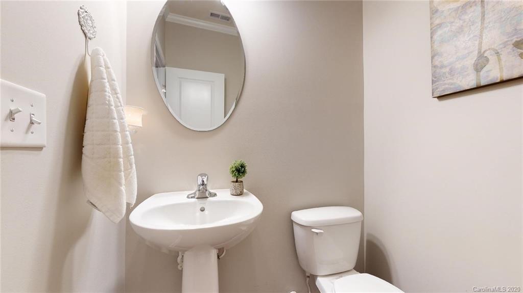 3010 Fallondale Road Waxhaw, NC 28173 - Photo 7 of 44 a bathroom with a toilet a sink and a mirror