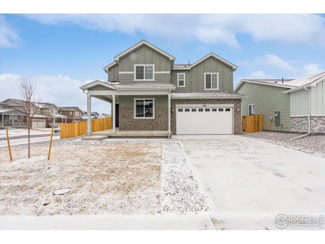 a front view of a house with large trees