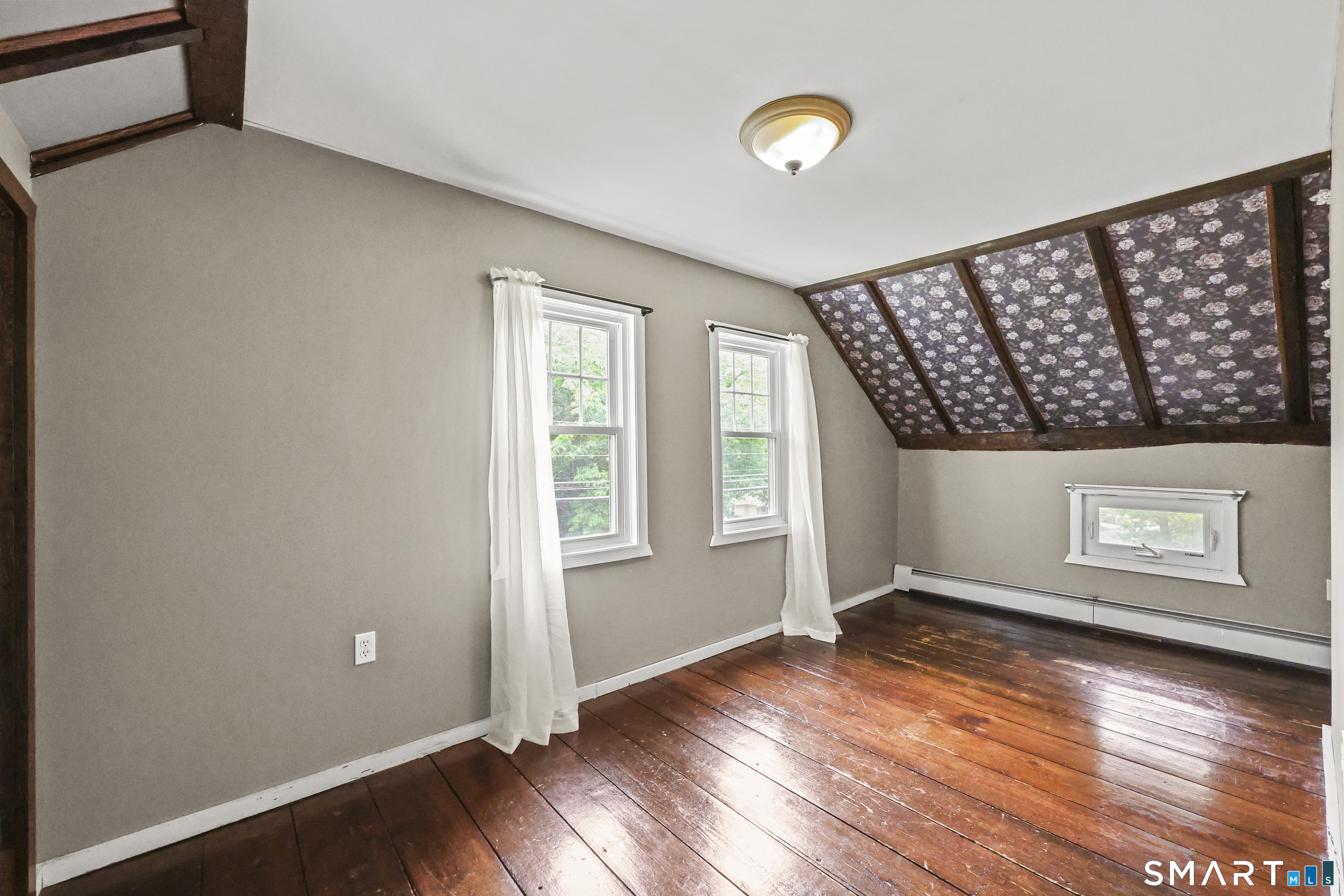 917 Hopewell Road Glastonbury, CT 06033 - Photo 20 of 39 an empty room with wooden floor and windows
