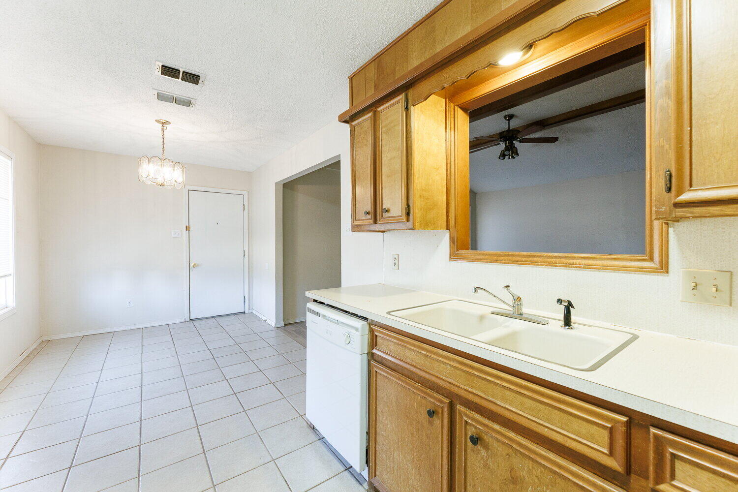 5809 Emory Street Lubbock, TX 79416 - Photo 16 of 30 a bathroom with a sink a vanity and a mirror