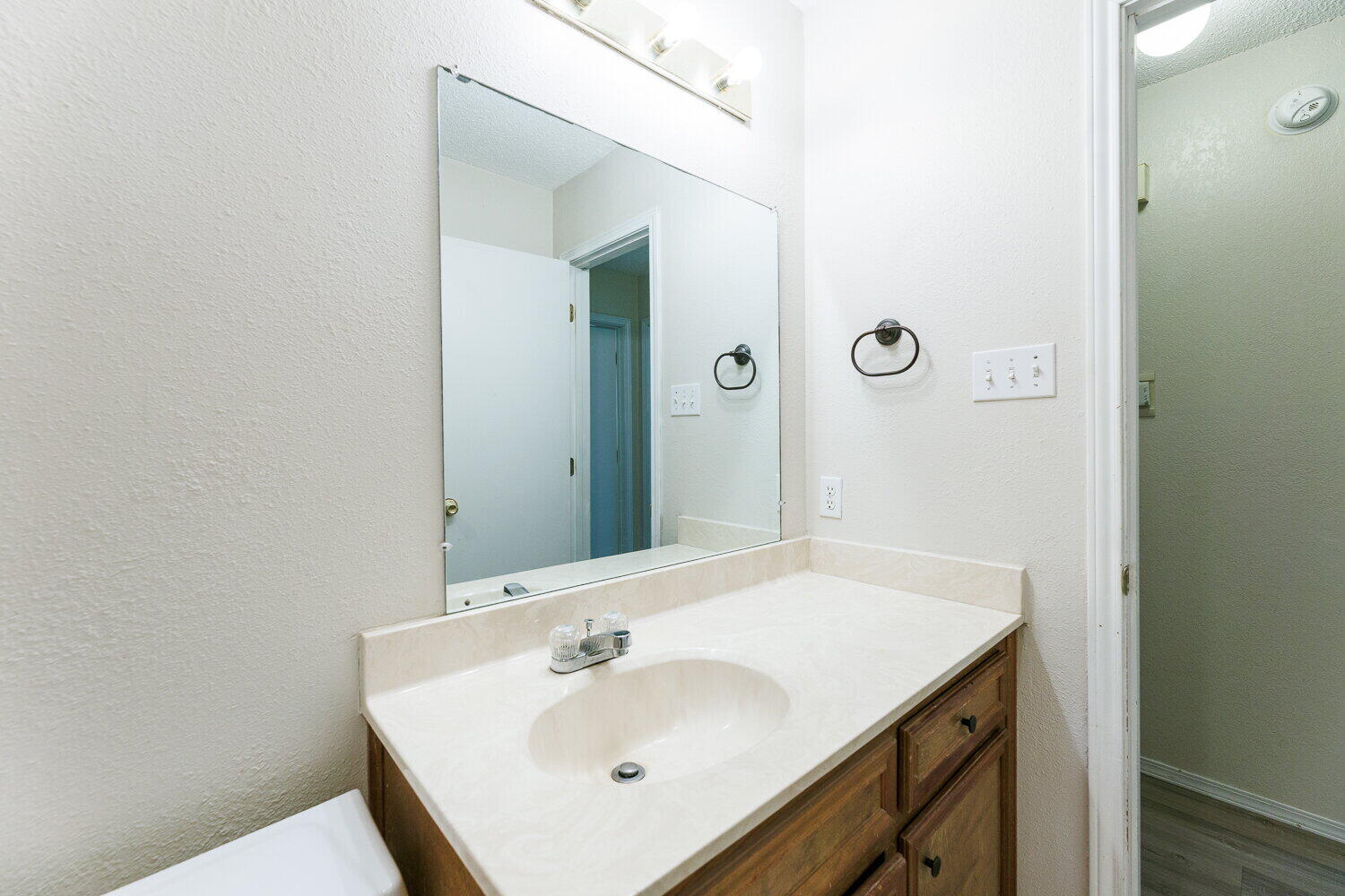 5809 Emory Street Lubbock, TX 79416 - Photo 27 of 30 a bathroom with a sink and a mirror
