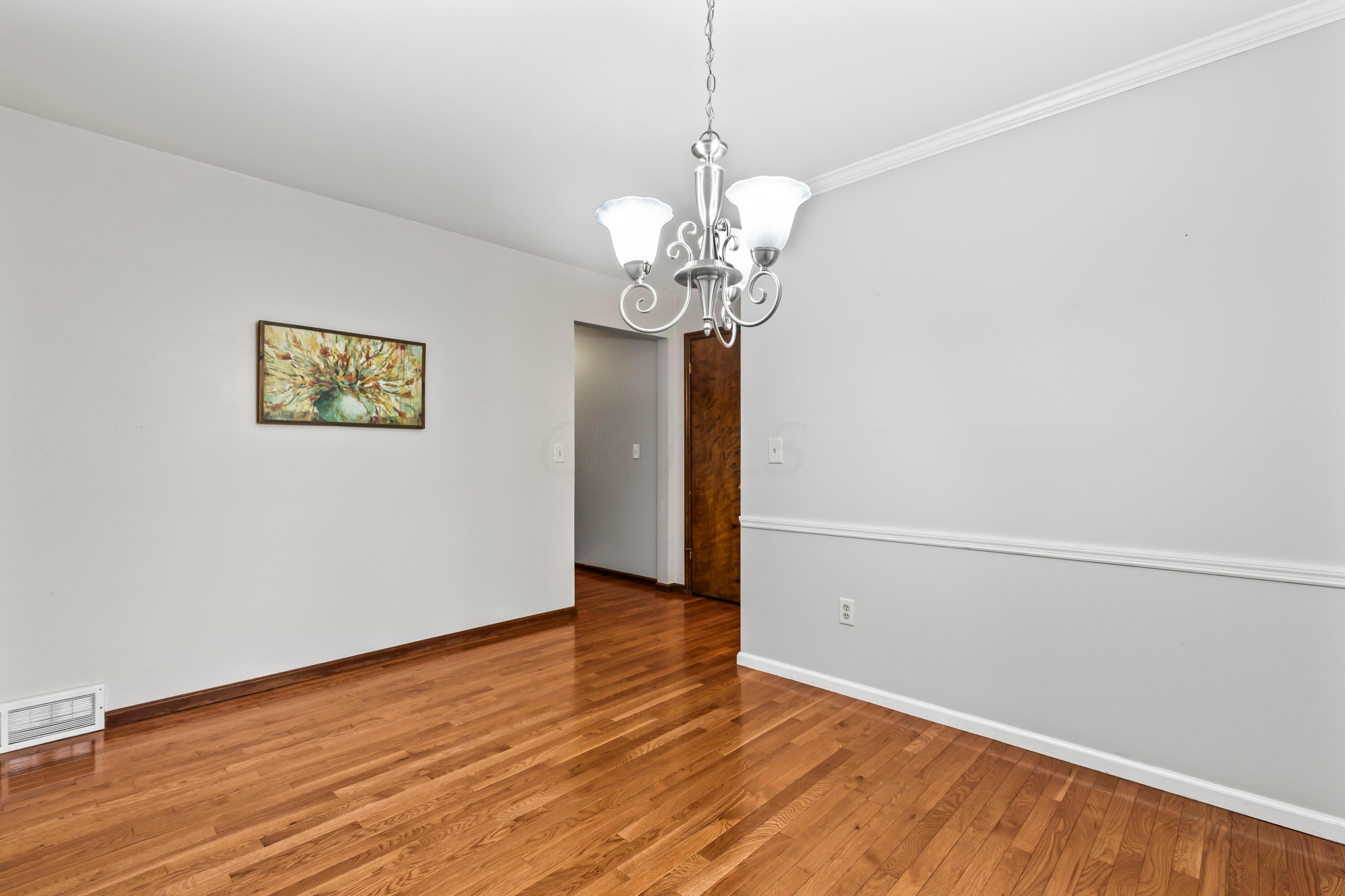 7020 Rieber Street Columbus, OH 43085 - Photo 9 of 40 • New hardwood flooring ~ 2012 • Grey painted walls • Crown molding • New chandelier ~ 2012 • Sliding doors to screened porch • Drapes are negotiable