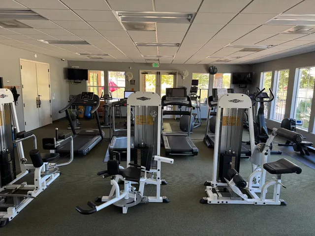 a room with gym equipment and a large window