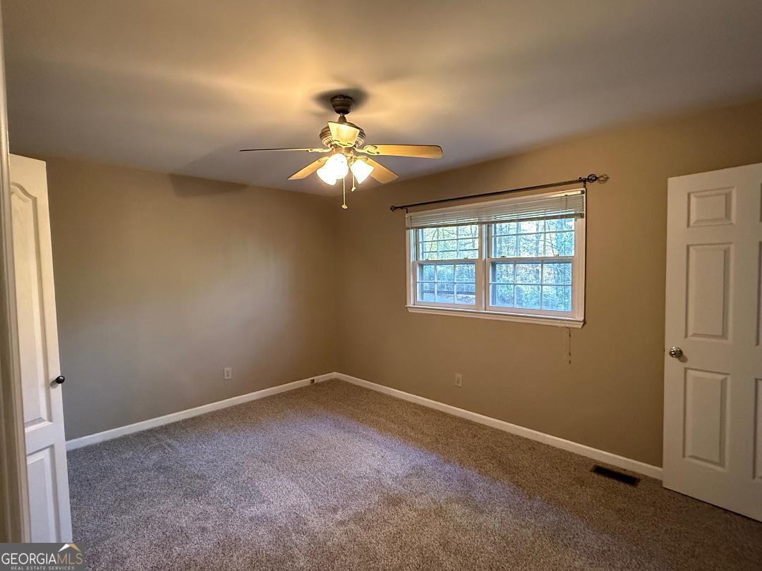 238 Settlers Point Clarkesville, GA 30523 - Photo 11 of 27 an empty room with windows and fan
