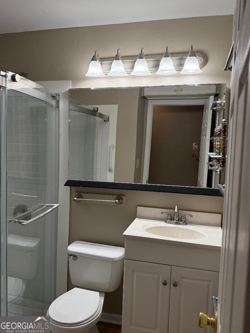 238 Settlers Point Clarkesville, GA 30523 - Photo 13 of 27 a bathroom with a granite countertop toilet sink and mirror