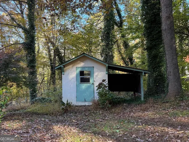 a front view of house with yard and trees in the background