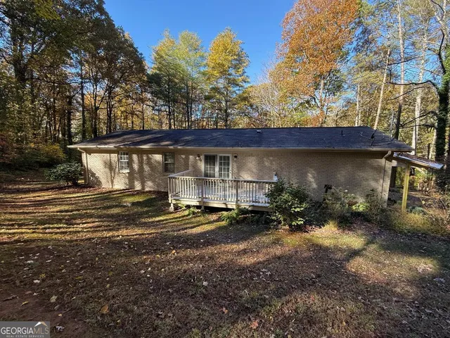 a view of a house with backyard and sitting area