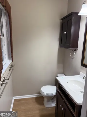 a bathroom with a toilet a sink and mirror