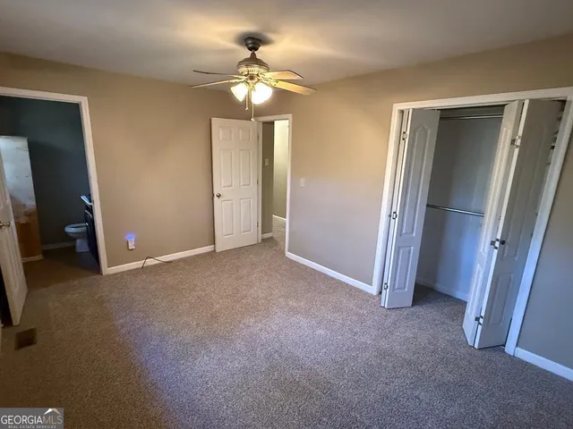 a view of an empty room with a mirror