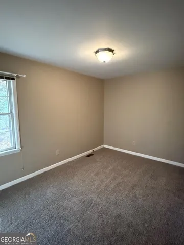 an empty room with a empty space and window