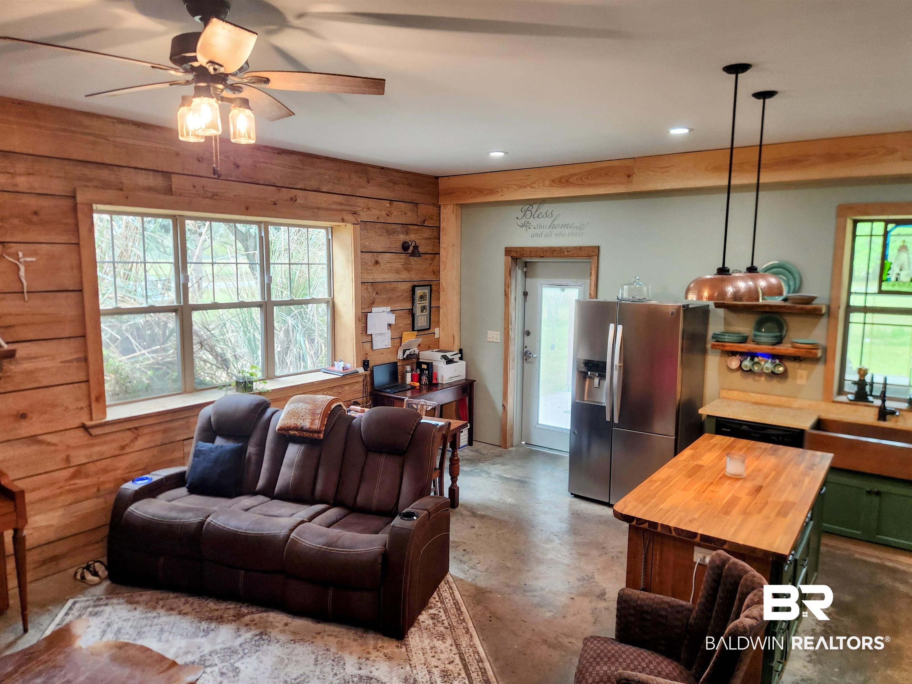 15461 Highway 98 Foley, AL 36535 - Photo 5 of 28 Living area with concrete floors, wood walls, recessed lighting, and a ceiling fan