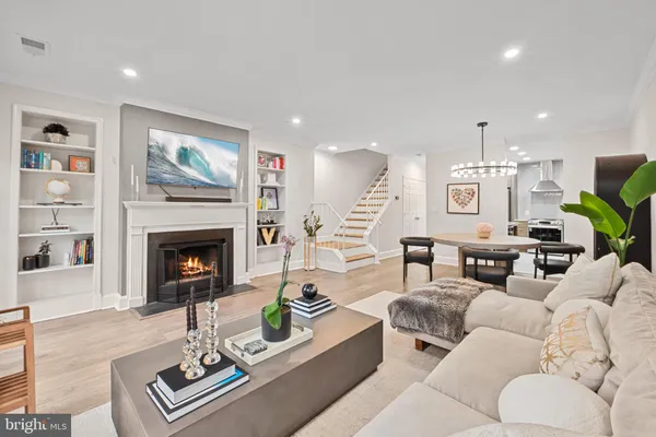 a living room with furniture a fireplace and a flat screen tv