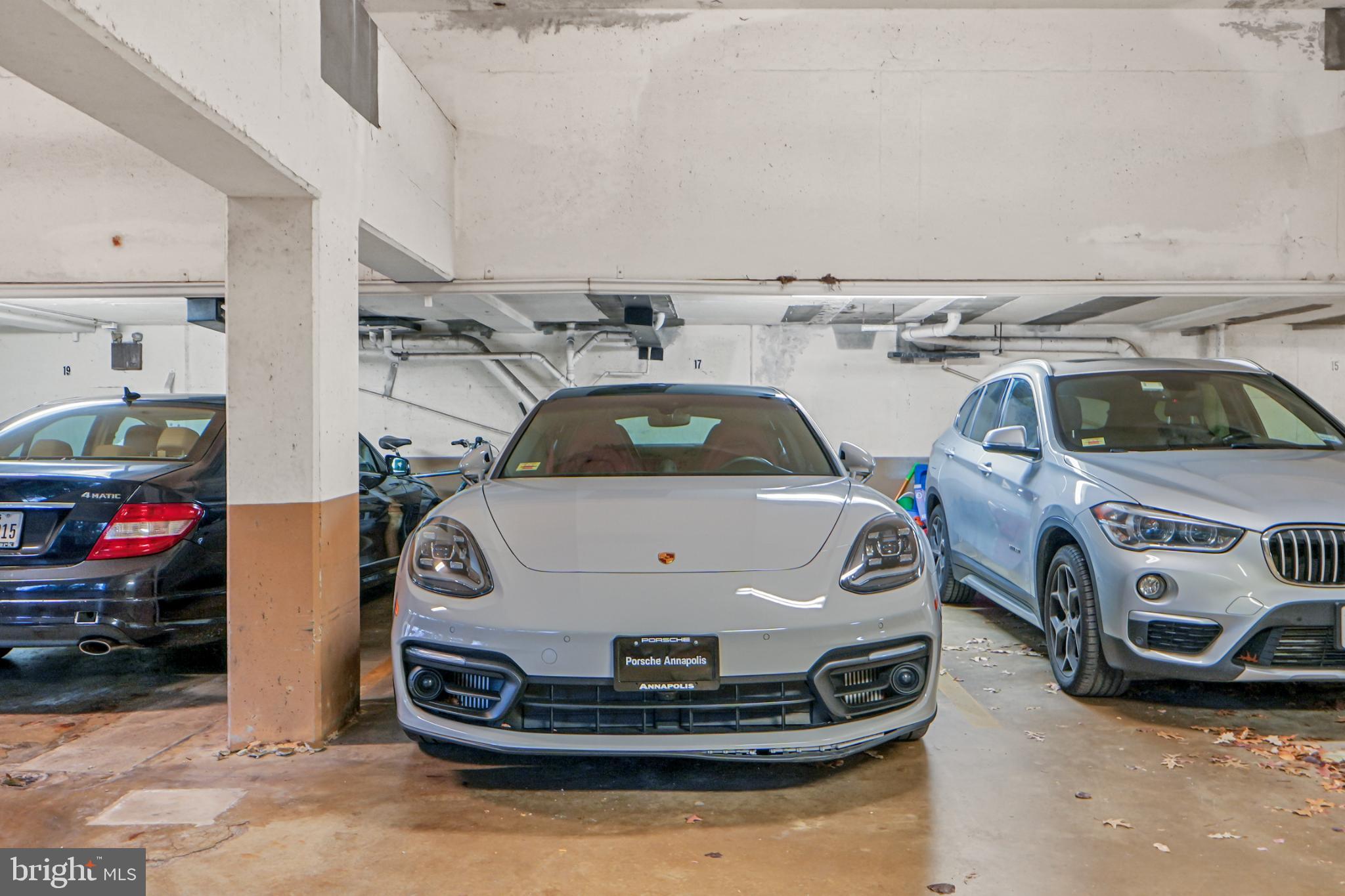 4311 Massachusetts Avenue Northwest Washington, DC 20016 - Photo 30 of 30 Luxury vehicles in a modern garage setting.