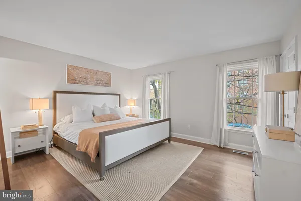 a bed room with a bed and a chair