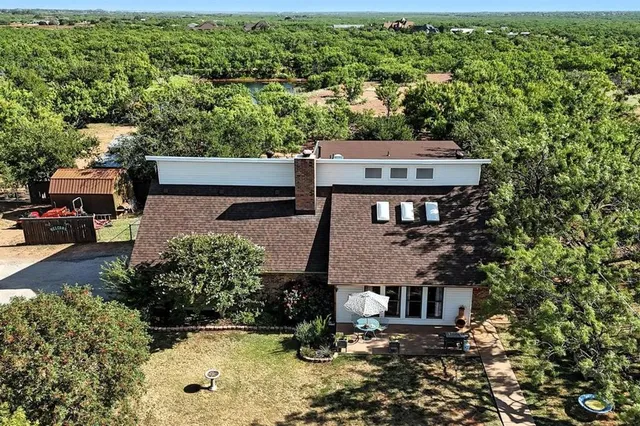 an aerial view of a house with a yard