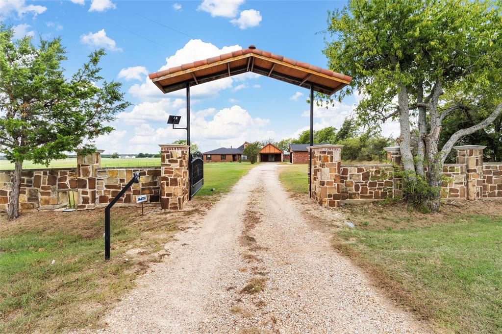 3433 West Tours Road West, TX 76691 - Photo 2 of 40 View of dirt / gravel road with a gated entry