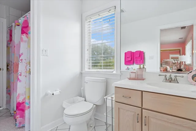 a bathroom with a sink vanity mirror and toilet