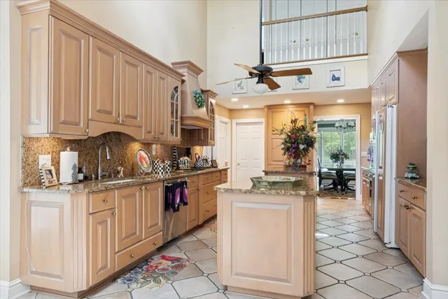 a kitchen with stainless steel appliances granite countertop a stove and cabinets