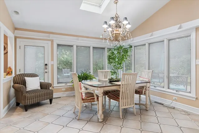 a view of a dining room with furniture and a chandelier