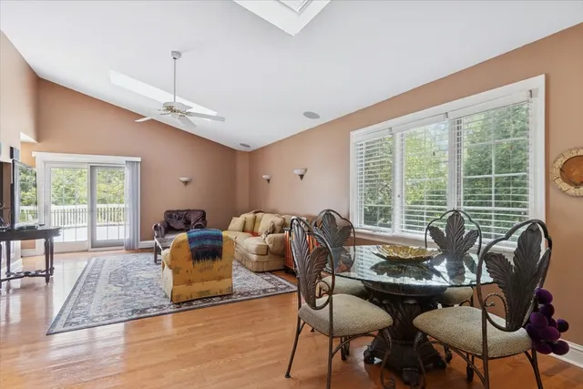 a living room with furniture and floor to ceiling windows