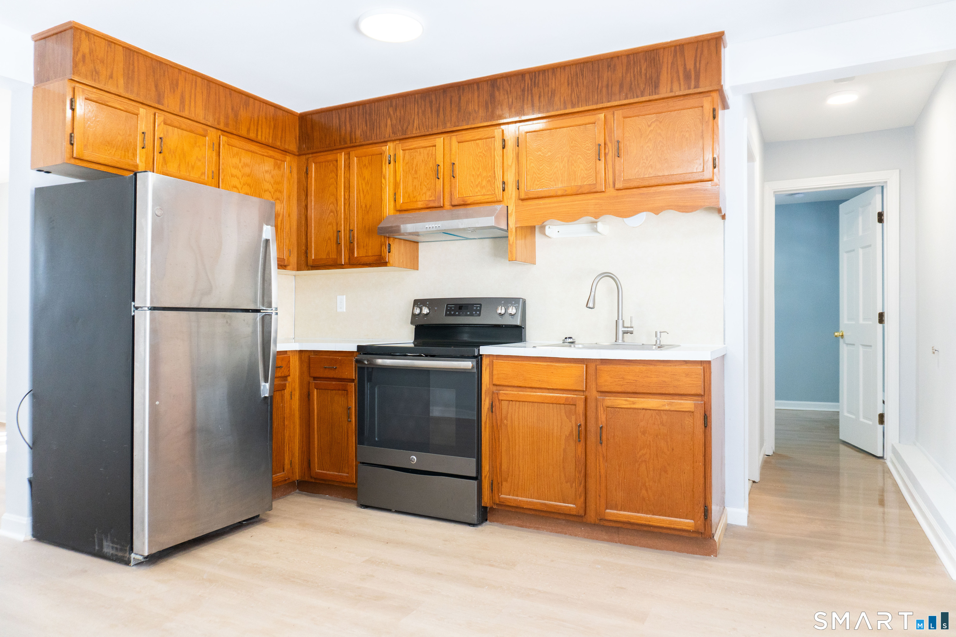 53 High Street Naugatuck, CT 06770 - Photo 11 of 28 a kitchen with stainless steel appliances a refrigerator and a stove