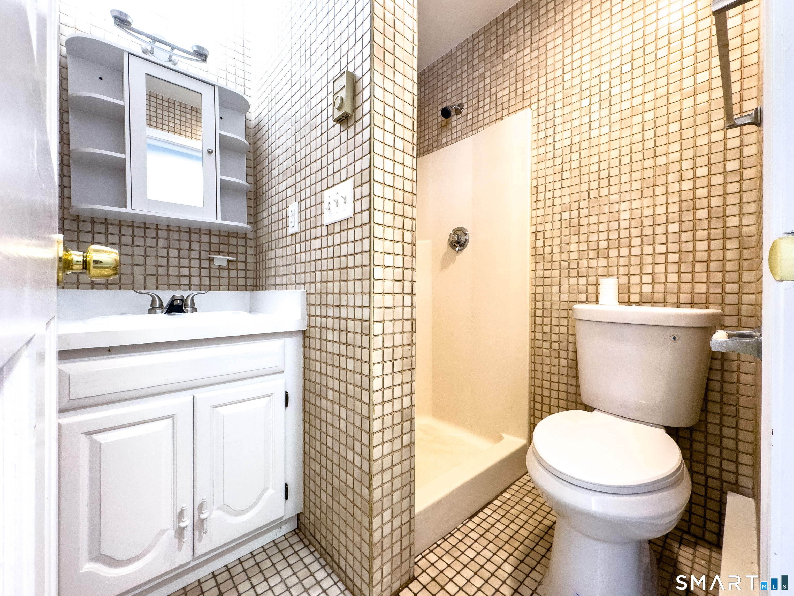 53 High Street Naugatuck, CT 06770 - Photo 13 of 28 a bathroom with a sink a toilet and a shower curtain