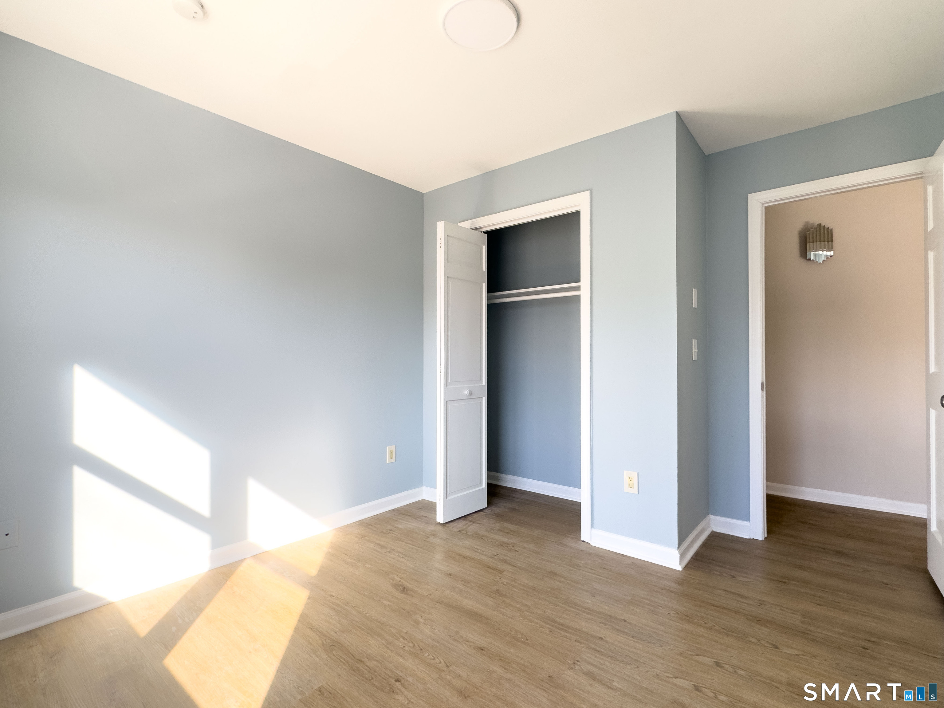 53 High Street Naugatuck, CT 06770 - Photo 18 of 28 a view of an empty room and window with wooden floor