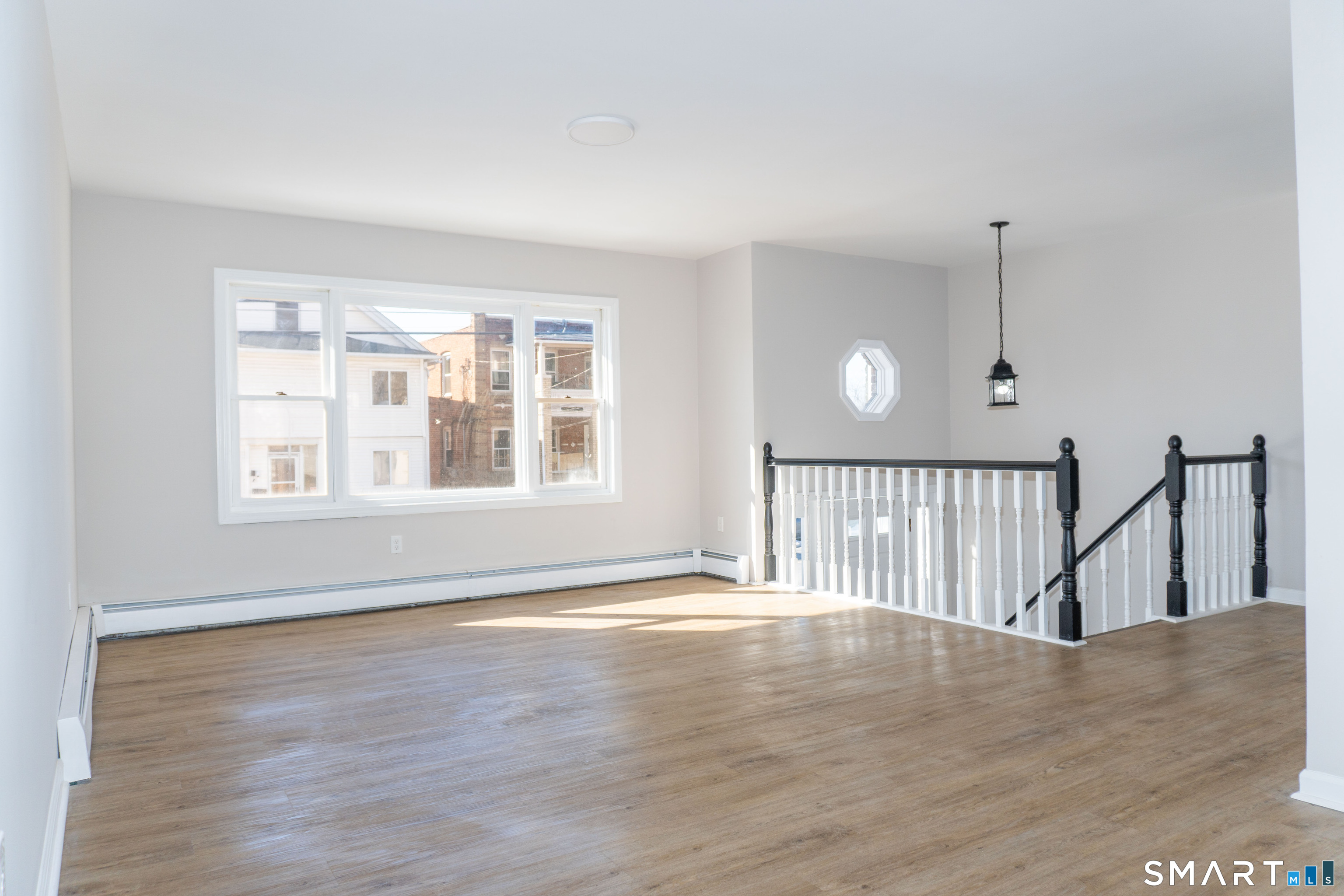 53 High Street Naugatuck, CT 06770 - Photo 4 of 28 a view of an empty room with wooden floor and a window