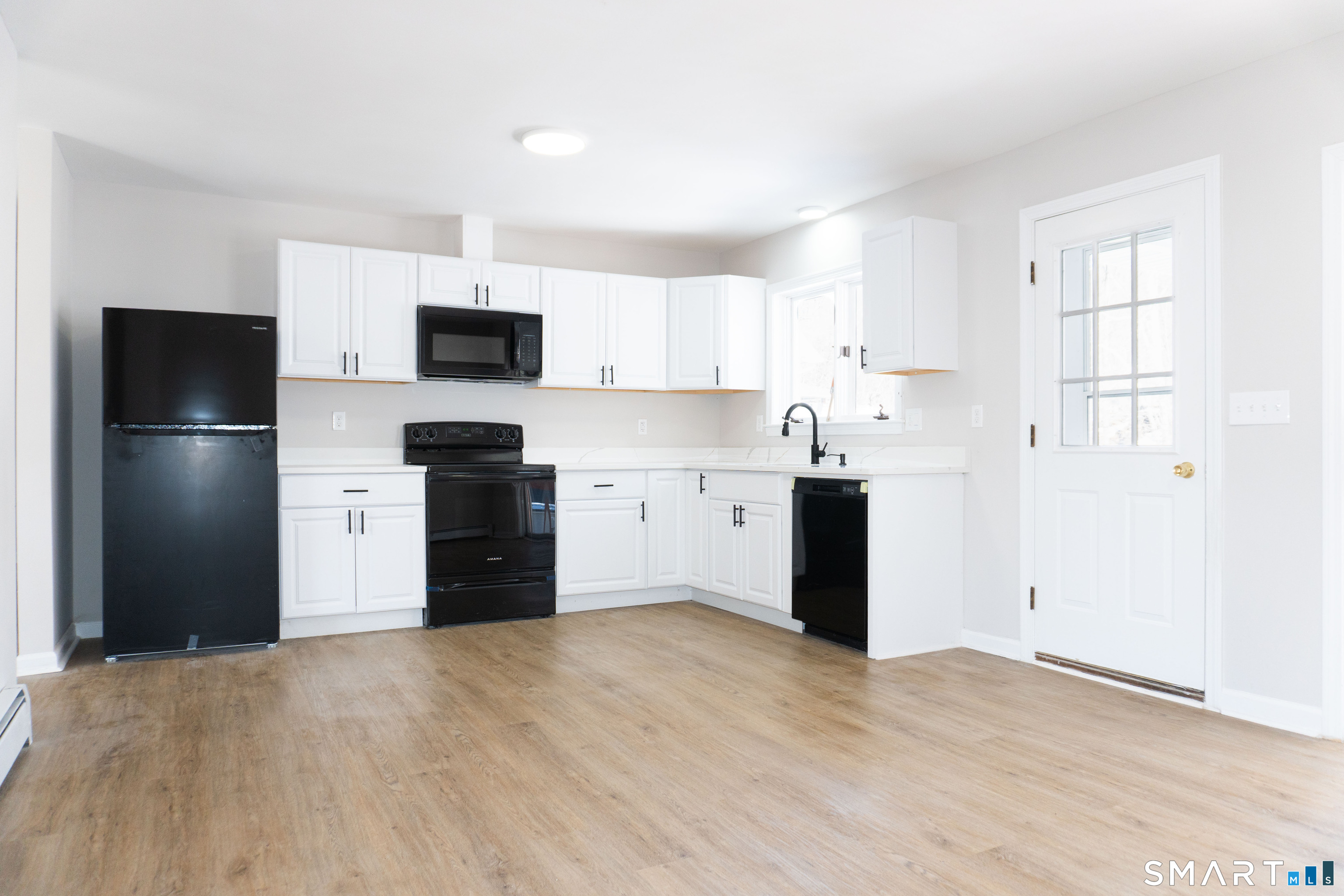 53 High Street Naugatuck, CT 06770 - Photo 5 of 28 a kitchen with a refrigerator and a stove top oven
