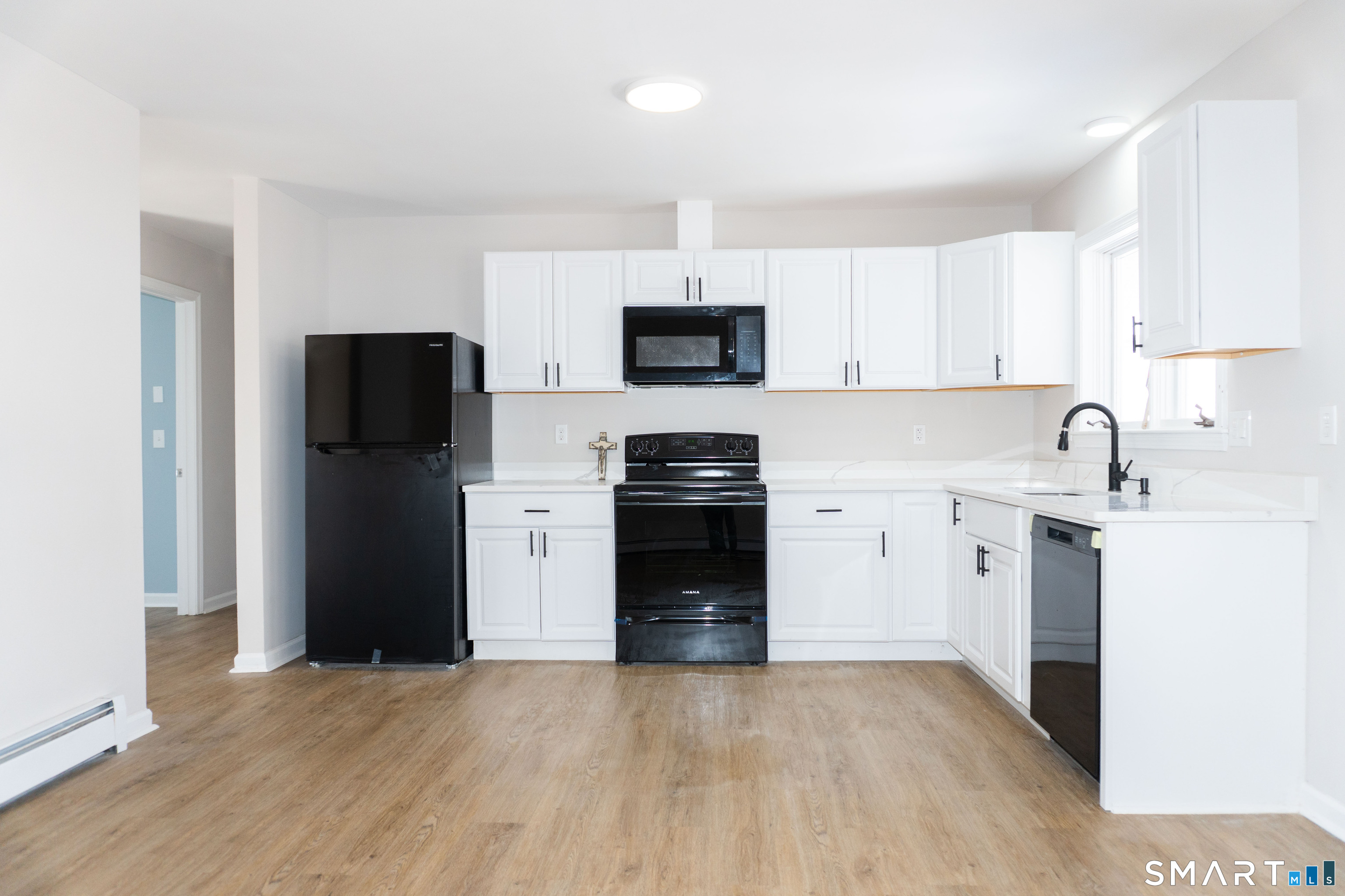 53 High Street Naugatuck, CT 06770 - Photo 6 of 28 a kitchen with a refrigerator stove and sink
