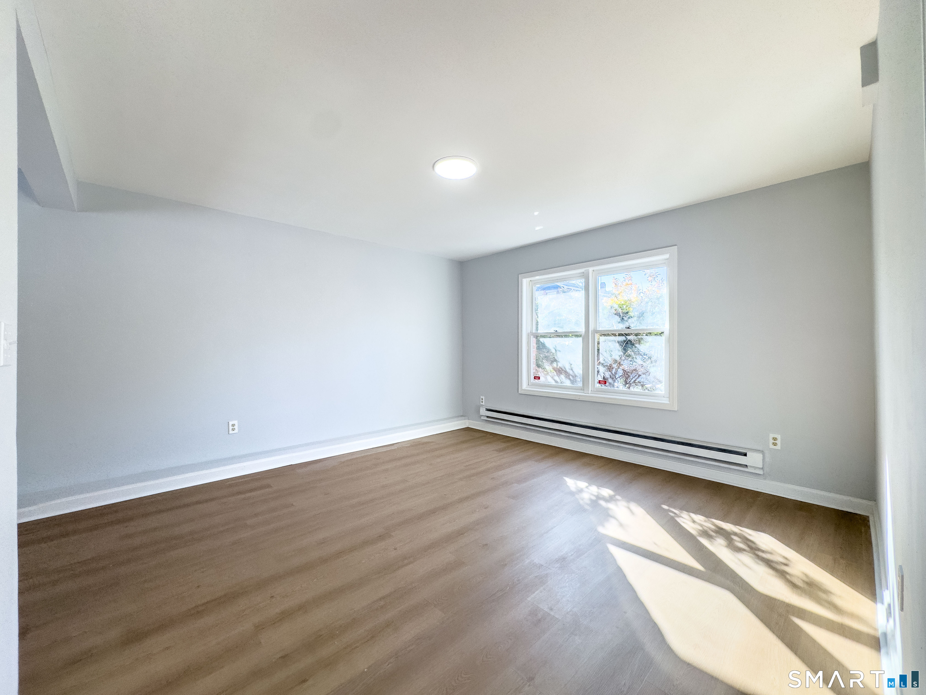 53 High Street Naugatuck, CT 06770 - Photo 8 of 28 an empty room with wooden floor and windows