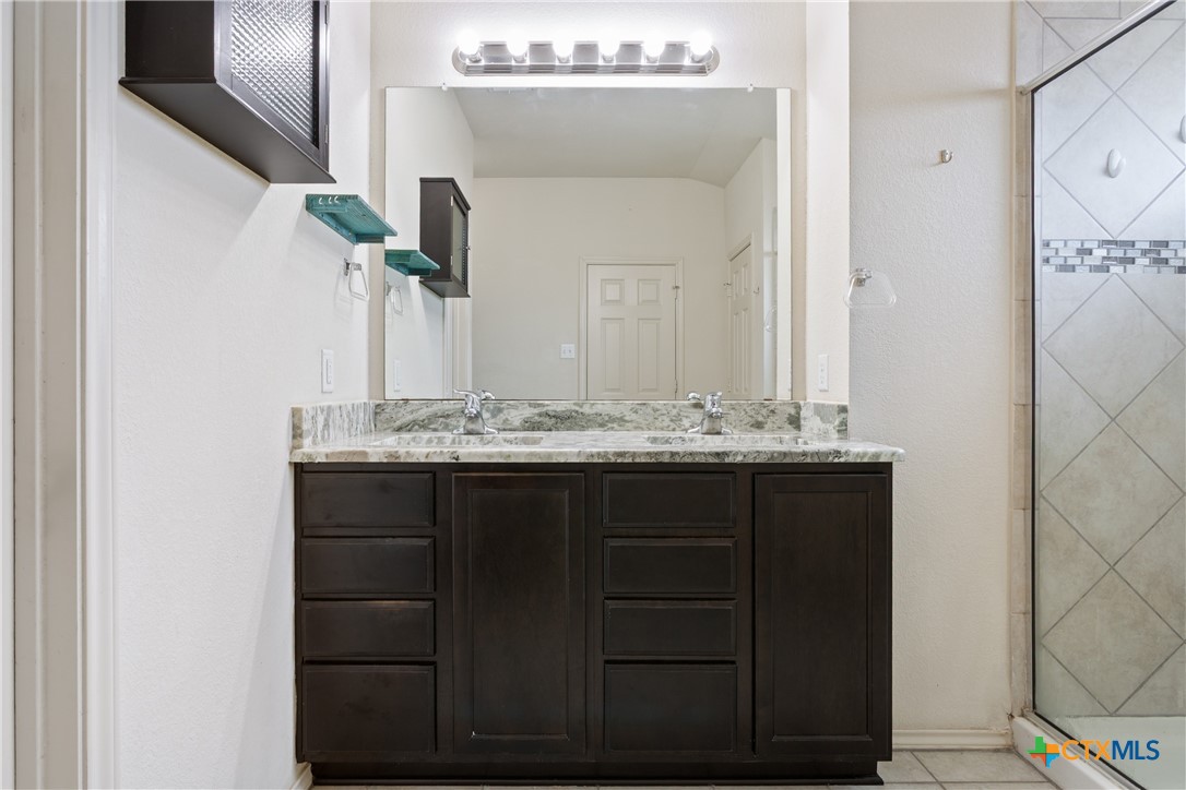 231 Druse Lane Jarrell, TX 76537 - Photo 16 of 38 a bathroom with a sink vanity and mirror