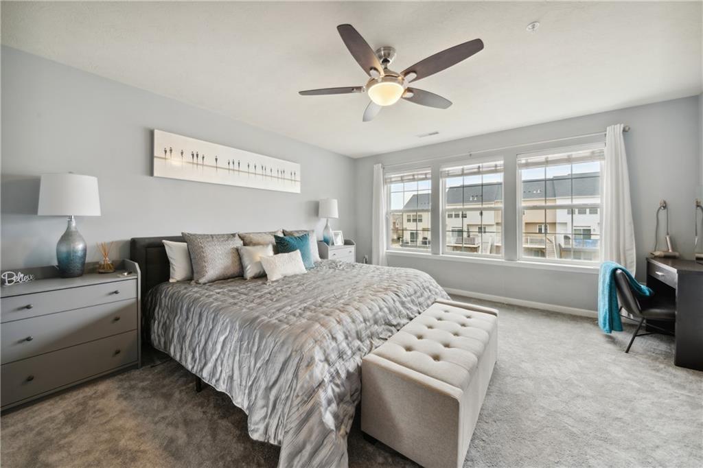 25 Truman Circle McKees Rocks, PA 15136 - Photo 11 of 25 a spacious bedroom with a bed a couch and large window