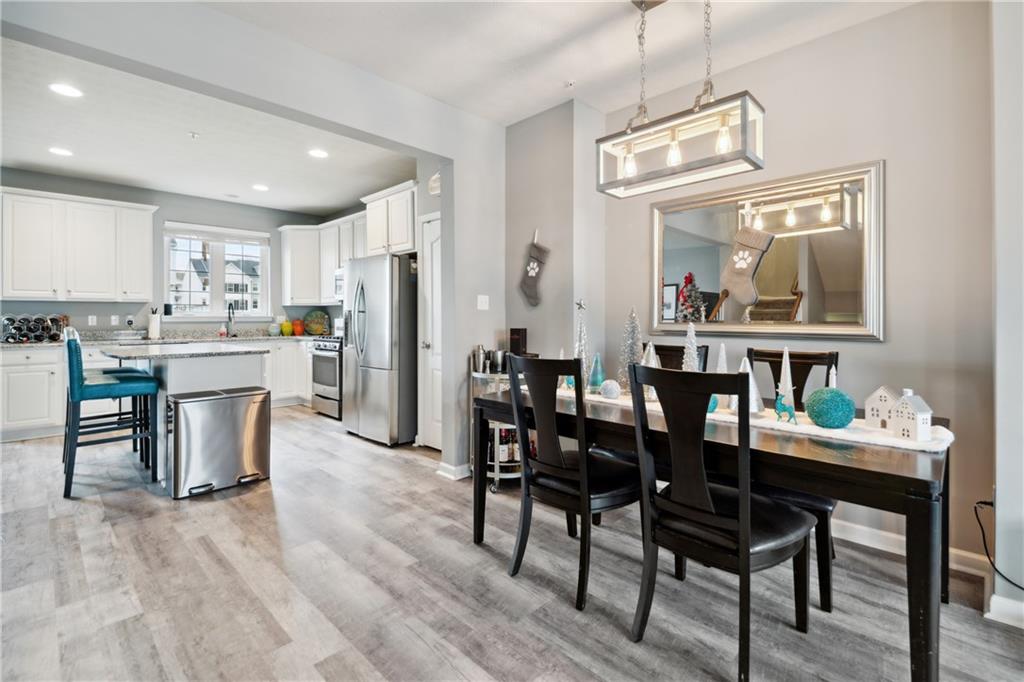 25 Truman Circle McKees Rocks, PA 15136 - Photo 4 of 25 a dining area with stainless steel appliances kitchen island granite countertop furniture a large window and kitchen view