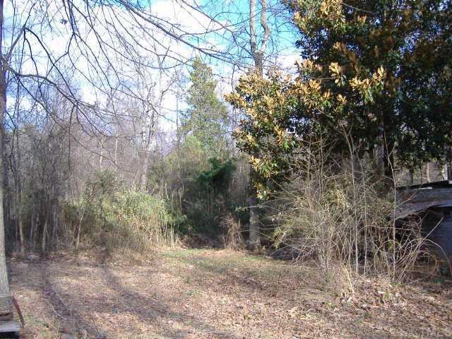 10666 Cleveland Road Garner, NC 27529 - Photo 3 of 10 a backyard of a house with lots of trees