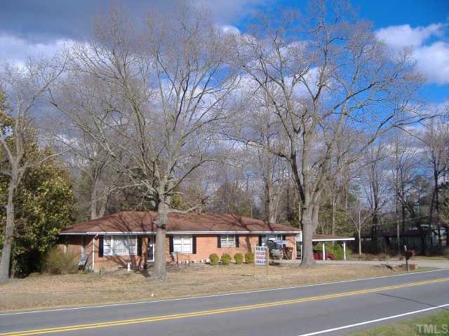 10666 Cleveland Road Garner, NC 27529 - Photo 9 of 10 a front view of a building with a garden and trees