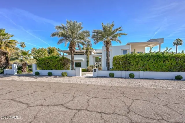 a living room with furniture and a ceiling fan