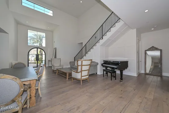 a bedroom with a large bed and a chandelier