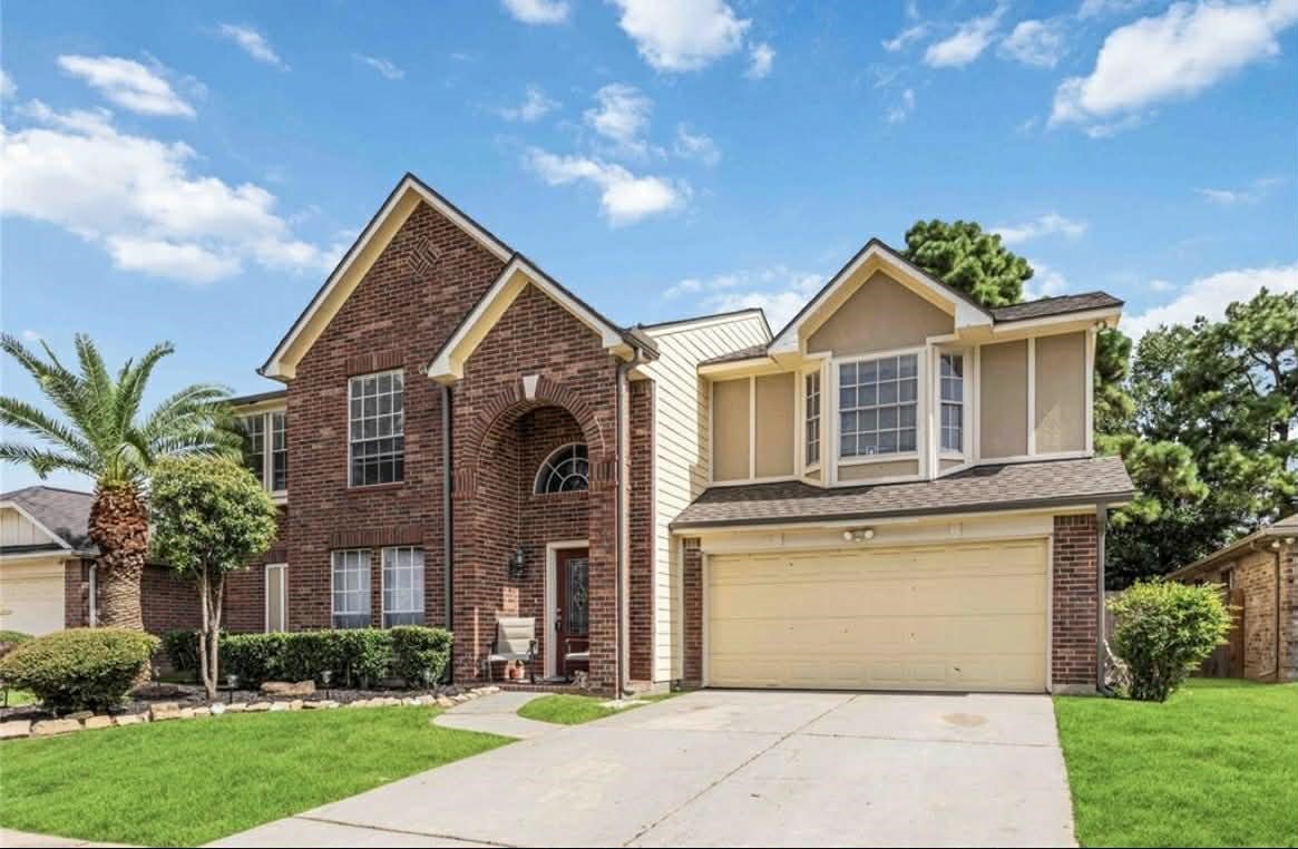 a front view of a house with a garden and plants