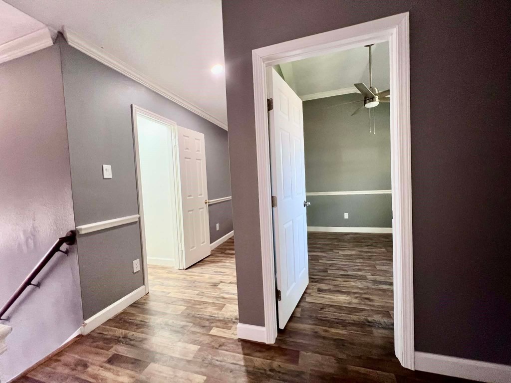 19514 Azalea Valley Drive Katy, TX 77449 - Photo 18 of 28 a view of a hallway with wooden floor and a bathroom