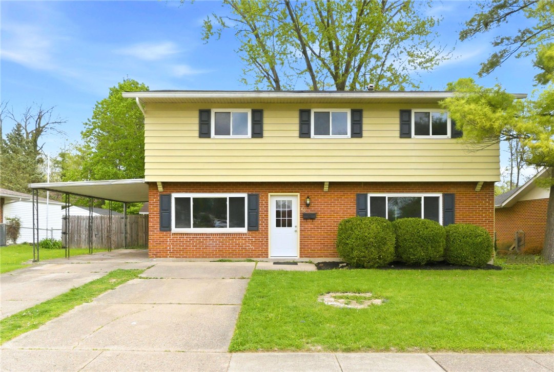 This classic two-story residence features a brick and siding exterior with a welcoming front entrance.