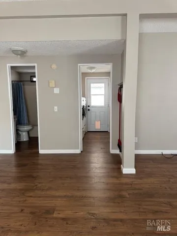 a view of a hallway with wooden floor