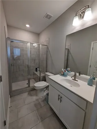 a bathroom with a double vanity sink toilet and shower