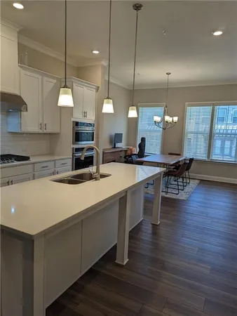 an open kitchen with a table and chairs in it