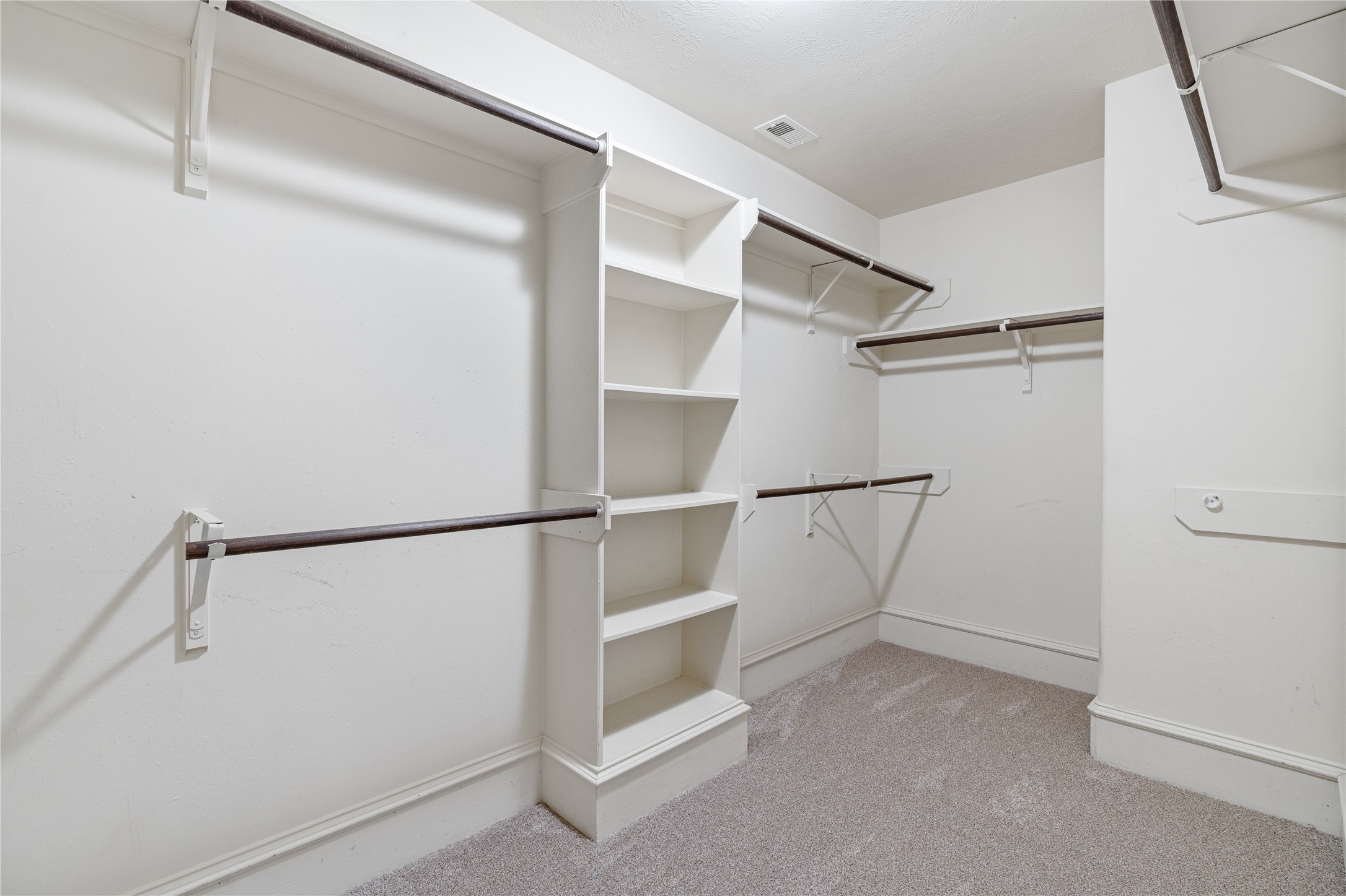 2115 Graystone Ridge Drive Conroe, TX 77304 - Photo 24 of 47 Primary suite includes a spacious walk-in closet offering generous storage, excellent organization potential, and plenty of room for wardrobe, shoes, and accessories.