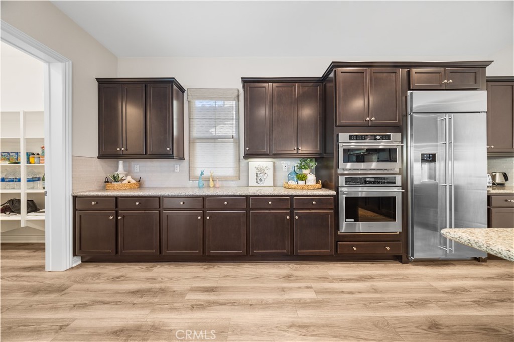 111 Lovelace Irvine, CA 92620 - Photo 14 of 55 a kitchen with stainless steel appliances granite countertop a refrigerator and a stove top oven