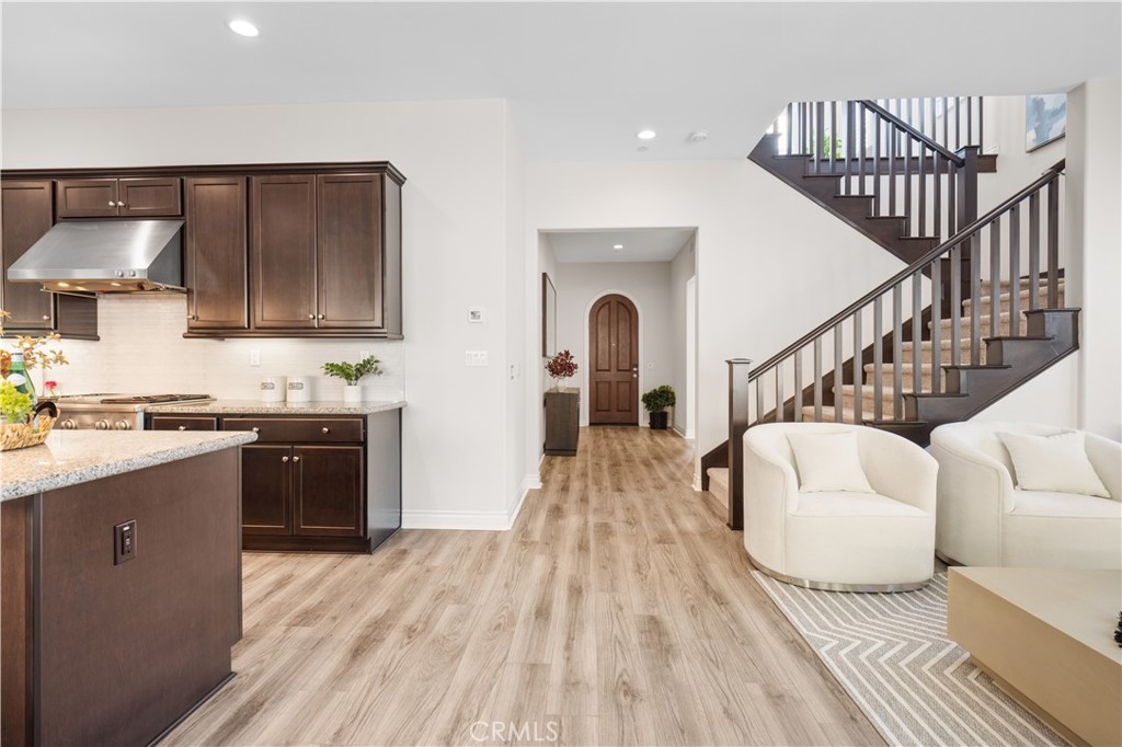 111 Lovelace Irvine, CA 92620 - Photo 16 of 55 a living room with white cabinets and a wooden floor