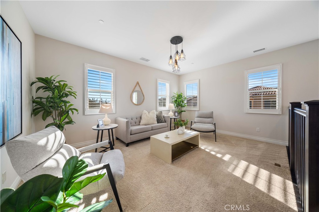 111 Lovelace Irvine, CA 92620 - Photo 21 of 55 a living room with furniture a chandelier and a window