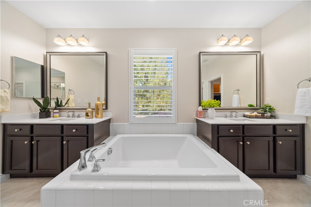 111 Lovelace Irvine, CA 92620 - Photo 34 of 55 a spacious bathroom with a tub sink and mirror